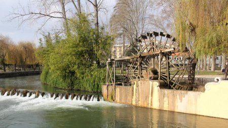 Replica of the old-time wooden Hydraulic Wheel typical for Nabao River region, used for irrigation and water mills, installed in 2011, Tomar, Portugal - February 6, 2024