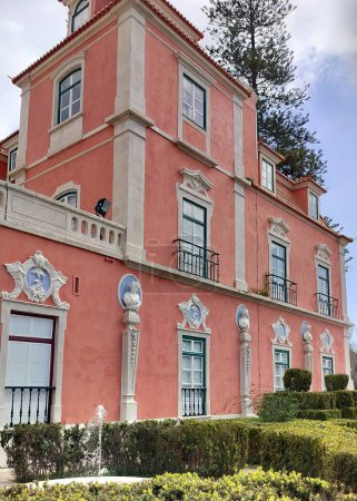 Marques de Pombal Palace, built in second half of the 18th century in Baroque and Rococo styles, garden side view with manicured hedges, Oeiras, Lisbon, Portugal - March 5, 2024