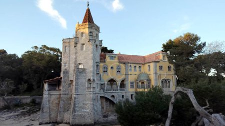 Palace of Counts of Castro Guimaraes, built in 1900 in eclectic architectural style as an aristocrats summer residence, in sunset light and shadows, Cascais, Portugal - March 5, 2024