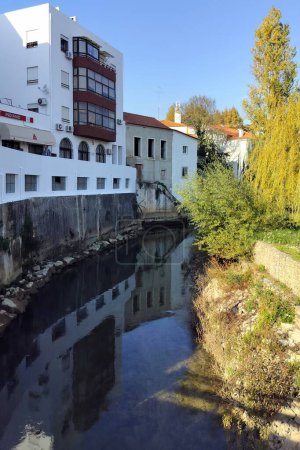 River Almonda, running along the edge of the old town, Torres Novas, Portugal - November 25, 2023