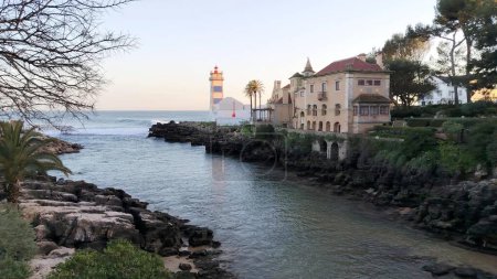 Santa Marta Lighthouse, built on the grounds of the Santa Marta Fort, which now houses a lighthouse museum, view in sunset light, Cascais, Portugal - March 5, 2024