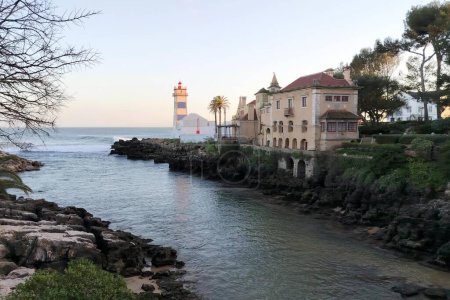 Santa Marta Lighthouse, built on the grounds of the Santa Marta Fort, which now houses a lighthouse museum, view in sunset light, Cascais, Portugal - March 5, 2024