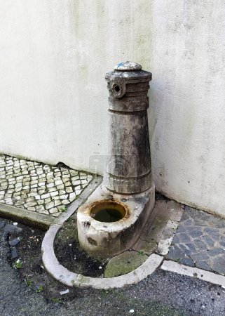 Old drinking water fountain on the side of a street, in the Amoreiras neighborhood, Lisbon, Portugal - February 28, 2024
