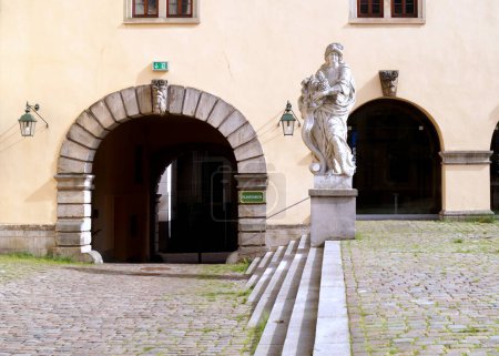 Cornucopia, classical sculpture in the cobblestone courtyard of Vonderau Museum, at the entrance to Planetarium, Fulda, Germany - May 10, 2022