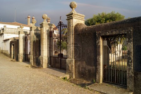 Elaborate gates with stone carved posts of the Morocco House, Idanha-a-Velha, Portugal - May 18, 2023