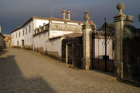 Elaborate gates with stone carved posts of the Morocco House, Idanha-a-Velha, Portugal - May 18, 2023