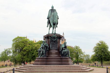 Bronze equestrian statue of Friedrich Franz II, the Grand Duke of Mecklenburg-Schwerin, allegories on the four virtues of a ruler: strength, righteousness, wisdom, and faith, Schwerin, Germany - May 3, 2012