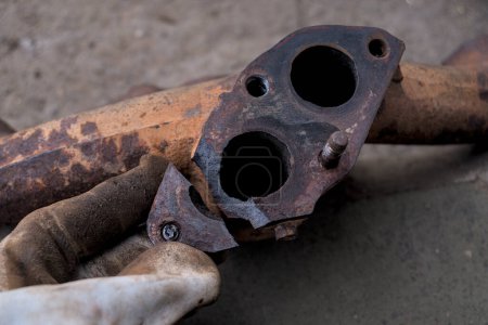 Burst cast iron exhaust manifold of a car