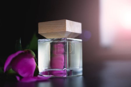 Perfume bottle and pink petals