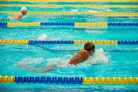 Photo for Kyiv, Ukraine, 10.28.2023. Swimming competition at CSK ZSU sports complex. Turquoise swimming pool lanes, a symbol of sport and the Olympics. - Royalty Free Image