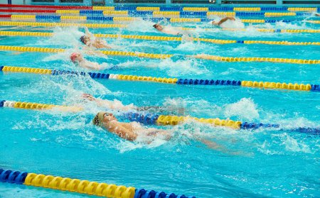 Photo for Kyiv, Ukraine, 10.28.2023. Swimming competition at CSK ZSU sports complex. Turquoise swimming pool lanes, a symbol of sport and the Olympics. Backstroke style. - Royalty Free Image