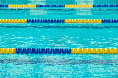 Photo for Turquoise swimming pool lanes, a symbol of sport - Royalty Free Image