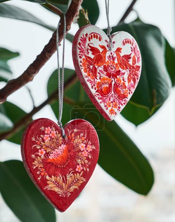 Photo for Red hearts set with Petrykivka painting. Ukrainian hand painted wooden ornament - Royalty Free Image