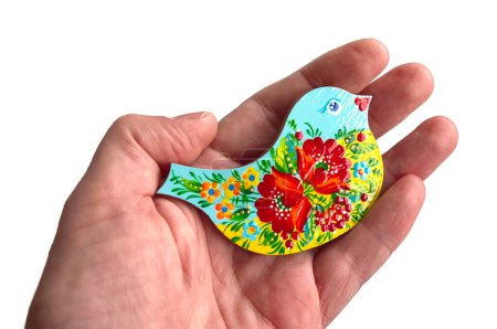 Photo for Dove of peace. Ukraine Peace Formula. Easter ornament bird with Petrykivka painting in the palm isolated on white background. - Royalty Free Image