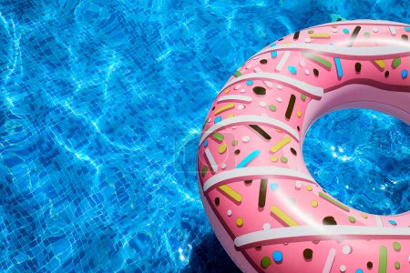 Pink inflatable ring in a blue outdoor pool. Poolside atmosphere. Pink float. Aqua party.