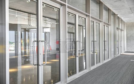 Revolving doors. The facade of a modern shopping center or station, an airport with revolving doors. Modern office entrance glass revolving door