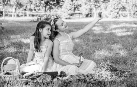Photo for Say cheese. Happy children take selfie at picnic. Selfie shooting. Modern life. New technology. Summer vacation. Family gathering. Eating outdoors. - Royalty Free Image