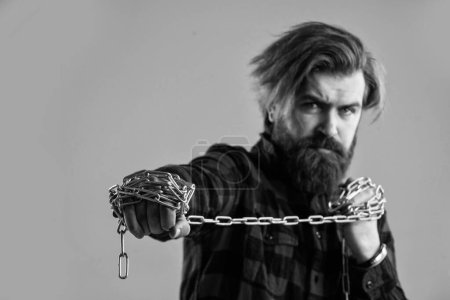 Photo for Brutal bearded man pull steel chain, Break the vicious circle. - Royalty Free Image
