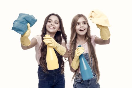 Photo for Protecting their home from dirt. Small housegirls dusting and cleaning home. Little home keepers holding spray bottles and wipers in rubber gloves. Services of home vacuuming and polishing. - Royalty Free Image