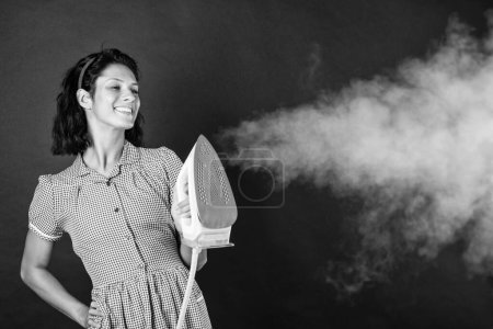 Photo for Lets do it. happy pinup woman. retro maid holding modern iron. housework is fun. Retro woman ironing clothes. Housekeeper in retro dress with iron. Order services. good wife concept. - Royalty Free Image