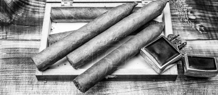 Cigars in box and vintage lighter. Cuban cigars. Cigar smoking. Cigar tobacco.