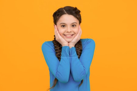 Photo for Smiling child with long hairdo. cheerful teen with healthy smile. Hair braided in braids. little beauty pleasantly surprised. happy childhood. small girl has nice smile. kid hairstyle fashion. - Royalty Free Image