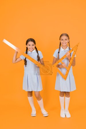 Photo for Study math. School students study math. Pupil school girls rulers. School knowledge. Explore world with math. Mathematical theory combining algebraic and geometric methods. Measure size. Really big. - Royalty Free Image