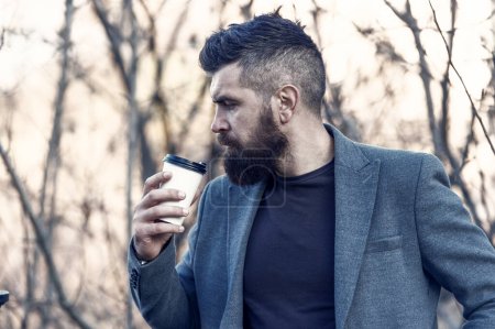 Photo for Time for myself. Hipster hold paper coffee cup. Relaxing coffee break. Businessman bearded guy drink coffee outdoors. Drink it on the go. Man thoughtful bearded hipster prefer coffee take away. - Royalty Free Image