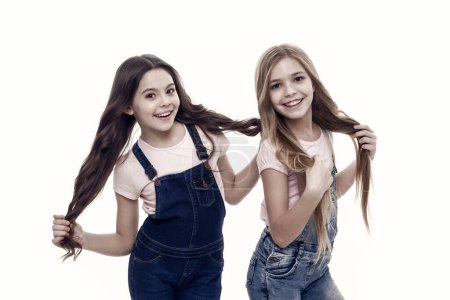 Being great every day. Adorable small girls with long hair. Cute little girls wearing new hairstyle. Kids hair care and grooming. Beauty and hair salon. Natural hair styling and dressing.