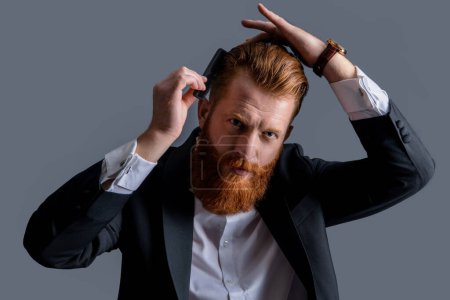 Photo for Man combing beard with hair comb. barbershop concept. barbershop man combing hair isolated on grey background. barbershop man with beard combing hair. man has beard in barbershop studio. - Royalty Free Image