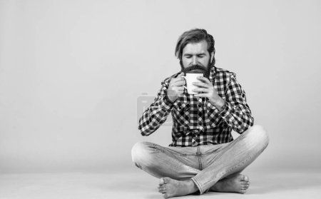 Photo for Hold cup of coffee or tea. lifestyle concept. handsome hipster man with cup of coffee. he is taking a coffee break. Handsome mature guy drinking from cup. - Royalty Free Image
