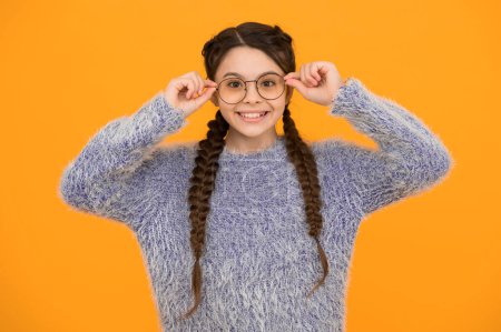 Photo for Focus on what matters. cheerful teen has bad sight. Hair braided in braids. little beauty in glasses. happy childhood. small girl has nice smile. kid hairstyle fashion. smiling child with long hairdo. - Royalty Free Image