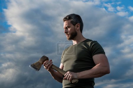 Photo for Man with axe. craftsman man hold ax. brutal man on dramatic sky background. - Royalty Free Image