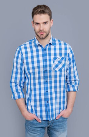 Photo for Young guy in checkered shirt isolated on grey background. guy in casual style. studio shot of guy. caucasian guy having stubble. - Royalty Free Image