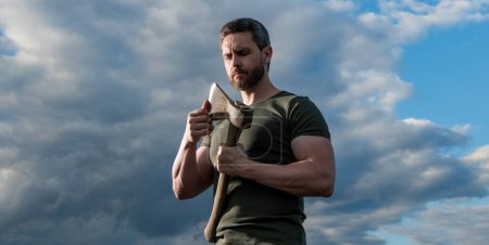 Photo for Man with axe. caucasian woodsman man hold ax. brutal man on dramatic sky background. - Royalty Free Image