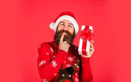 Photo for Lets do this. hipster enjoy the holiday. morning before Xmas. bearded man in sweater. man in santa hat await christmas present. ready for party celebration. new year shopping idea concept. - Royalty Free Image