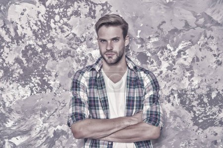 Style confidence. Confident guy. Guy keep arms crossed abstract background. Handsome guy in casual style. Unshaven guy wear plaid shirt. Fashion and style. Menswear store, vintage filter.