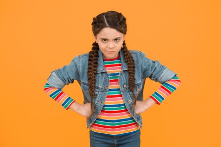 Photo for In bad humor. Moody little child yellow background. Little baby wear braided hairstyle. Little girl in casual style. Little kid with hands on hips. Trendy fashion. Stylish trends. Hair salon. - Royalty Free Image