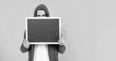 Photo for Male behind chalkboard. place for useful information. advertisement copy space. your marketing design. man in hood behind blackboard. guy make announcement. - Royalty Free Image