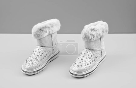 Photo for Pair of fashionable winter beige ugg boots on yellow background, new pair. - Royalty Free Image