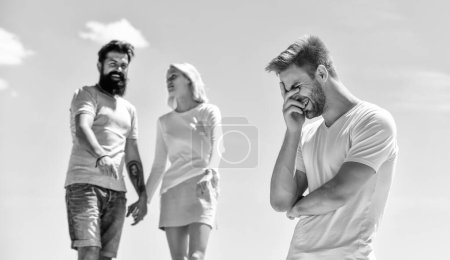 Photo for Look at him. relationship problems. sworn friends. interpersonal relationship. Misunderstanding. love triangle. Social. Betrayal and divorce. couple in love. third wheel man. family psychology. - Royalty Free Image