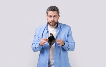 Photo for Amazed moneyless guy with wallet at hand. photo of moneyless guy with wallet. moneyless guy with wallet isolated on studio background. moneyless guy with wallet in studio. - Royalty Free Image