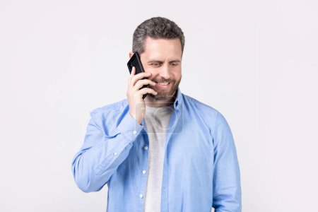 Photo for Photo of cheerful man having communication call. man has communication call on phone isolated on studio background. man with communication call in studio. communication call of man. - Royalty Free Image