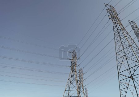 Photo for High-voltage. powerful substation on blue sky background with nobody. copy space. electrical power lines. pylon producing energy. voltage transmission on electric tower. - Royalty Free Image