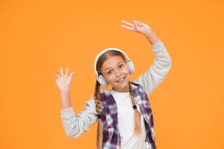 Photo for Wireless means freedom. Headphones with wireless technology. Small child listening to music modern wireless earphones. Happy little girl wearing modern headphones. Cute kid enjoying stereo sound. - Royalty Free Image