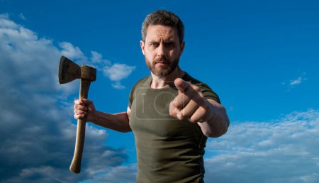 Photo for Man threaten with axe. caucasian man hold ax. brutal man on sky background. point finger. - Royalty Free Image
