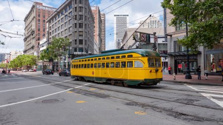 Photo for San Francisco, USA - May 19, 2019: yellow sfmta tramcar public transport in the city street. - Royalty Free Image