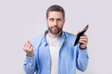 Photo for Moneyless guy with wallet isolated on studio background, crisis. moneyless guy with wallet in studio. moneyless guy with wallet at hand. photo of moneyless guy with wallet. - Royalty Free Image