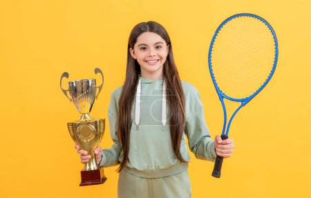 happy teen champion girl isolated on yellow. teen champion girl in studio. teen champion girl on background. photo of teen champion girl with tennis racket.