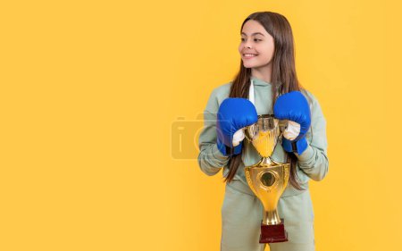 Photo for Teen boxing girl on background, advertisement. photo of teen boxing girl with champion cup. teen boxing girl isolated on yellow. teen boxing girl in studio. - Royalty Free Image
